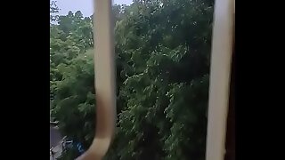 Husband fucking wife in doggy style by enjoying the rain from window